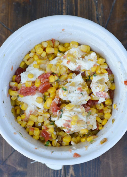 softened cream cheese stirred into the corn, tomato, green chili, ranch seasoning, and chopped green onions in a white slow cooker.