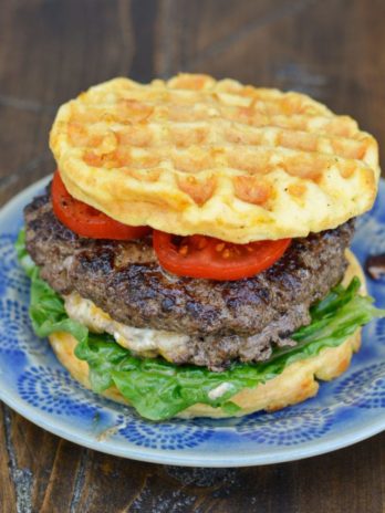 Keto Jalapeño Popper Burgers are the ultimate low carb dinner! Juicy burgers are loaded with creamy jalapeño popper filling and served on crispy chaffle buns!