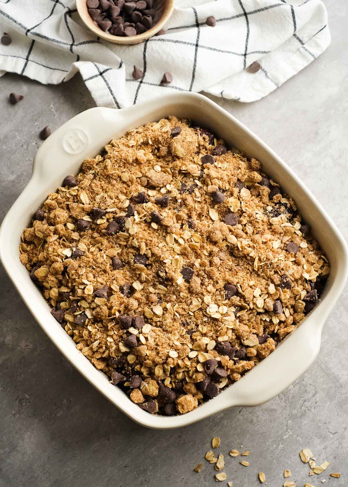unbaked cherry crisp with chocolate topping in a clear bowl