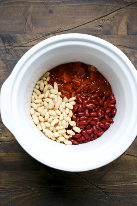 red kidney beans, canellini beans, and diced tomatoes in a slow cooker