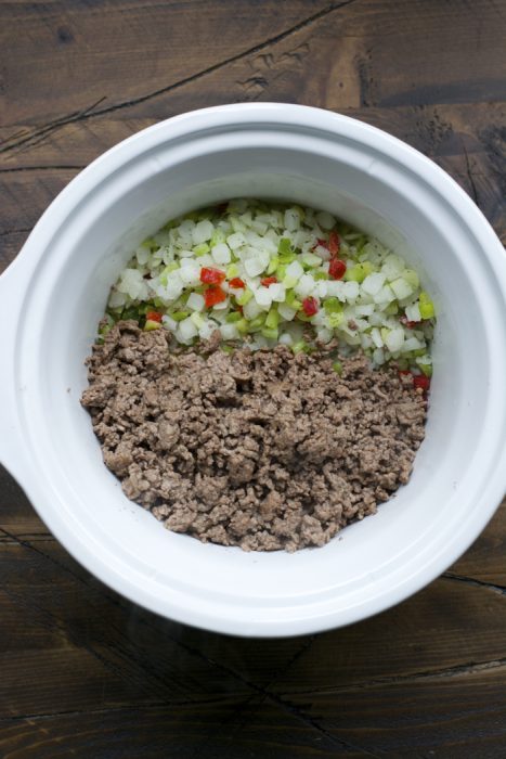 browned ground beef and diced frozen vegetables in a slow cooker