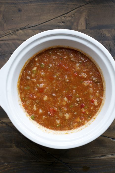 broth, beans, meat, vegetables, and marinara sauce mixed together in a slow cooker