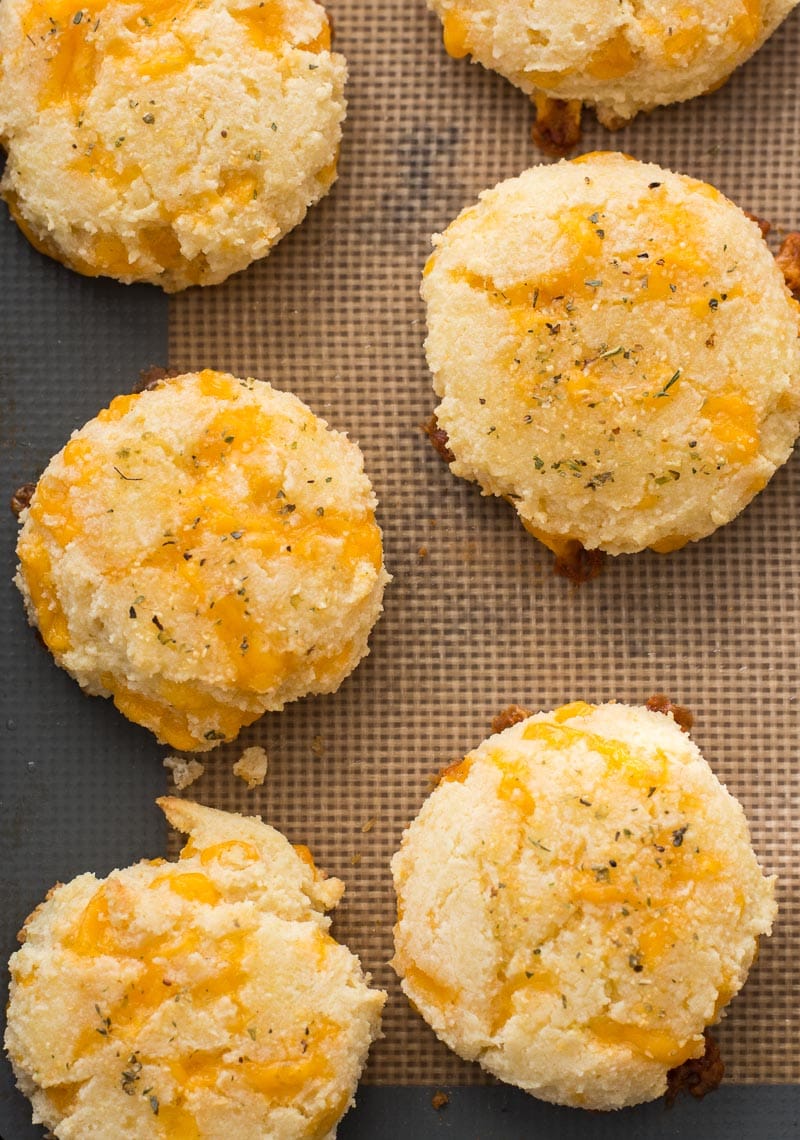 keto garlic cheddar biscuits on a silicone lined baking sheet