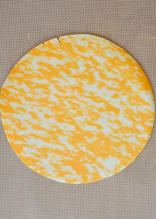 a cheddar cheese wrap on a silicone baking mat