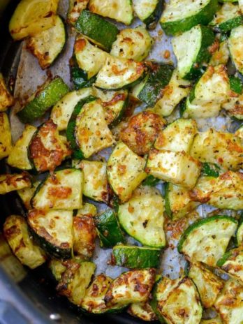 Learn how to make delicious Air Fryer Zucchini with Parmesan! This keto side dish has only four ingredients and is ready in under 10 minutes!