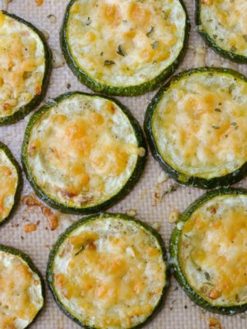 Overhead view of roasted zucchini slices topped with parmesan