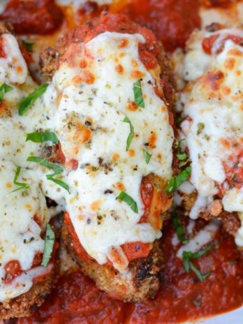 This Keto Chicken Parmesan is breaded and fried until perfectly crisp and smothered in marinara and mozzarella! At just five net carbs per serving, this is a classic dish your entire family will love!