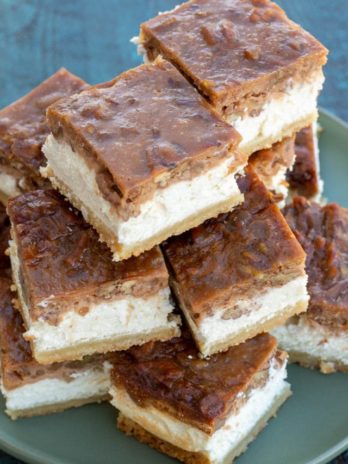 These Pecan Pie Cheesecake Bars feature a shortbread cookie crust, vanilla cheesecake and delicious pecan pie layer! This impressive dessert is keto-friendly and has just 5 net carbs per slice!