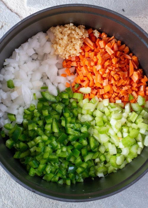 chopped garlic, onion, carrot, bell pepper, and celery in a large dutch oven