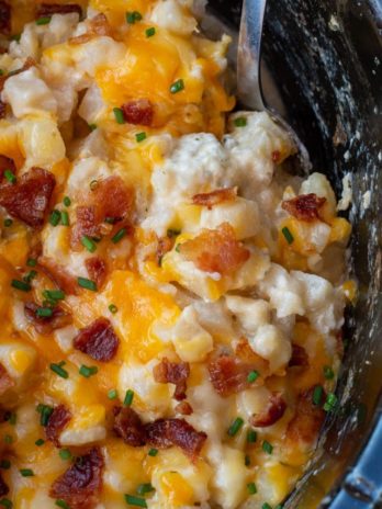 These Crockpot Cheesy Potatoes require a few basic ingredients and no prep! Simply dump the ingredients for these cheesy potatoes in a slow cooker, mix and forget it! This is the best side dish recipe!