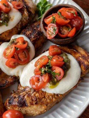 This Chicken Margherita recipe is full of fresh flavors! Balsamic Grilled Chicken is topped with fresh mozzarella, creamy pesto, and a bright tomato basil salad!