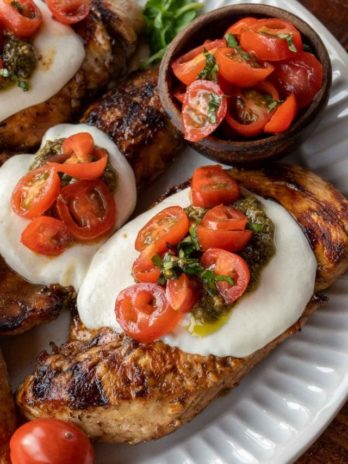 This Chicken Margherita recipe is full of fresh flavors! Balsamic Grilled Chicken is topped with fresh mozzarella, creamy pesto, and a bright tomato basil salad!