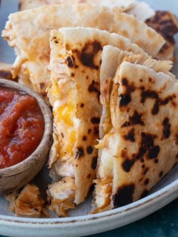 Learn how to make the best Chicken Quesadilla! This easy chicken recipe features a crispy tortilla loaded with two kinds of cheese, tender chicken, and a savory sauce.