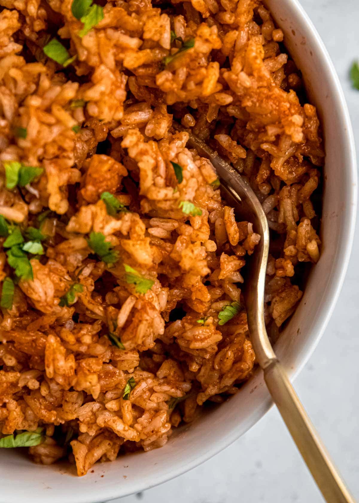 mexican rice in bowl with fork