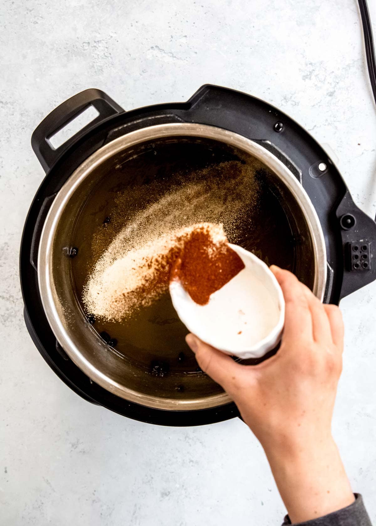 spices being added to instant pot