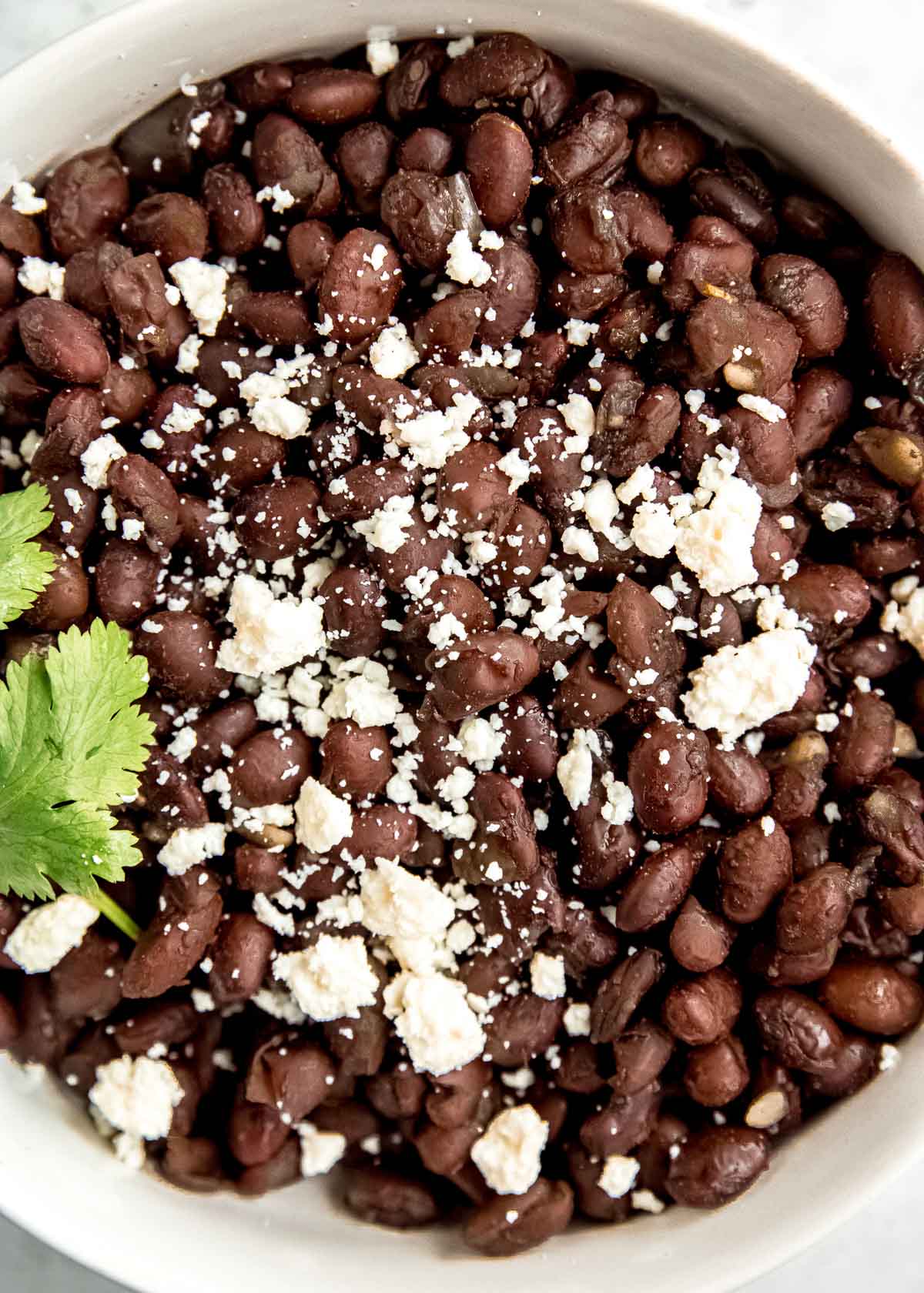 black beans in instant pot with crumbling cheese