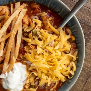 chicken tortilla soup in a blue bowl