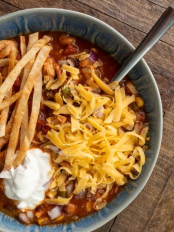 chicken tortilla soup in a blue bowl