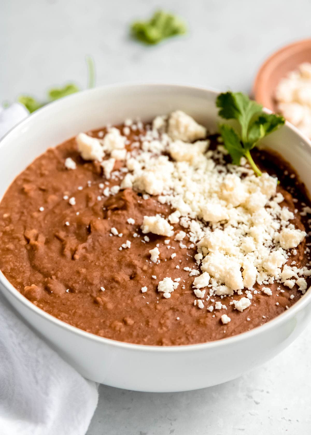 instant pot refried beans in a white bowl on a white table