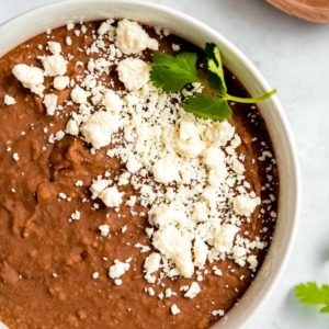 instant pot refried beans in a white bowl on a white table