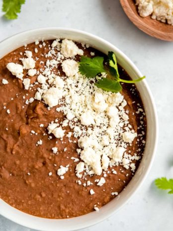 instant pot refried beans in a white bowl on a white table