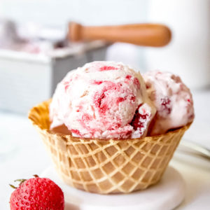 a waffle bowl full of homemade strawberry ice cream