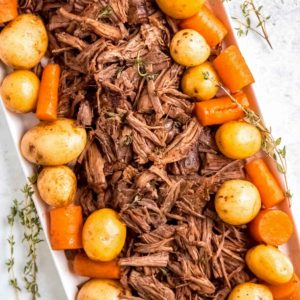 Instant Pot Pot Roast on a plate with potatoes and carrots