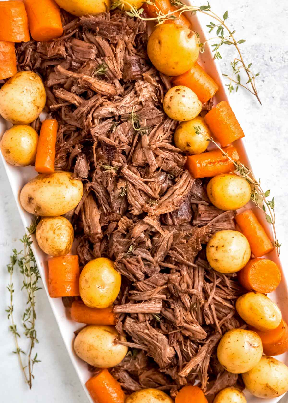 Instant Pot Pot Roast on a plate with potatoes and carrots