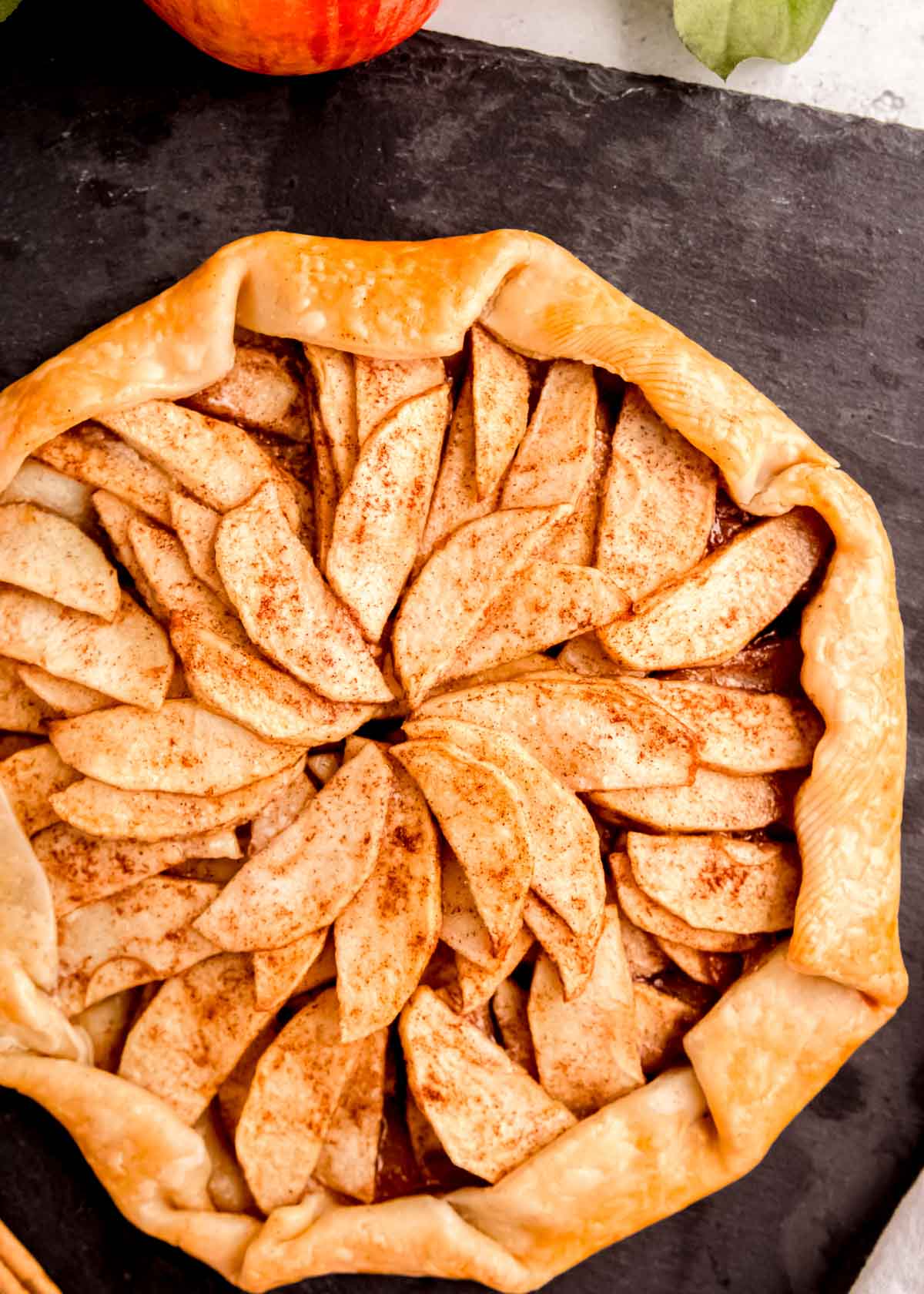 an apple galette on a slate serving board