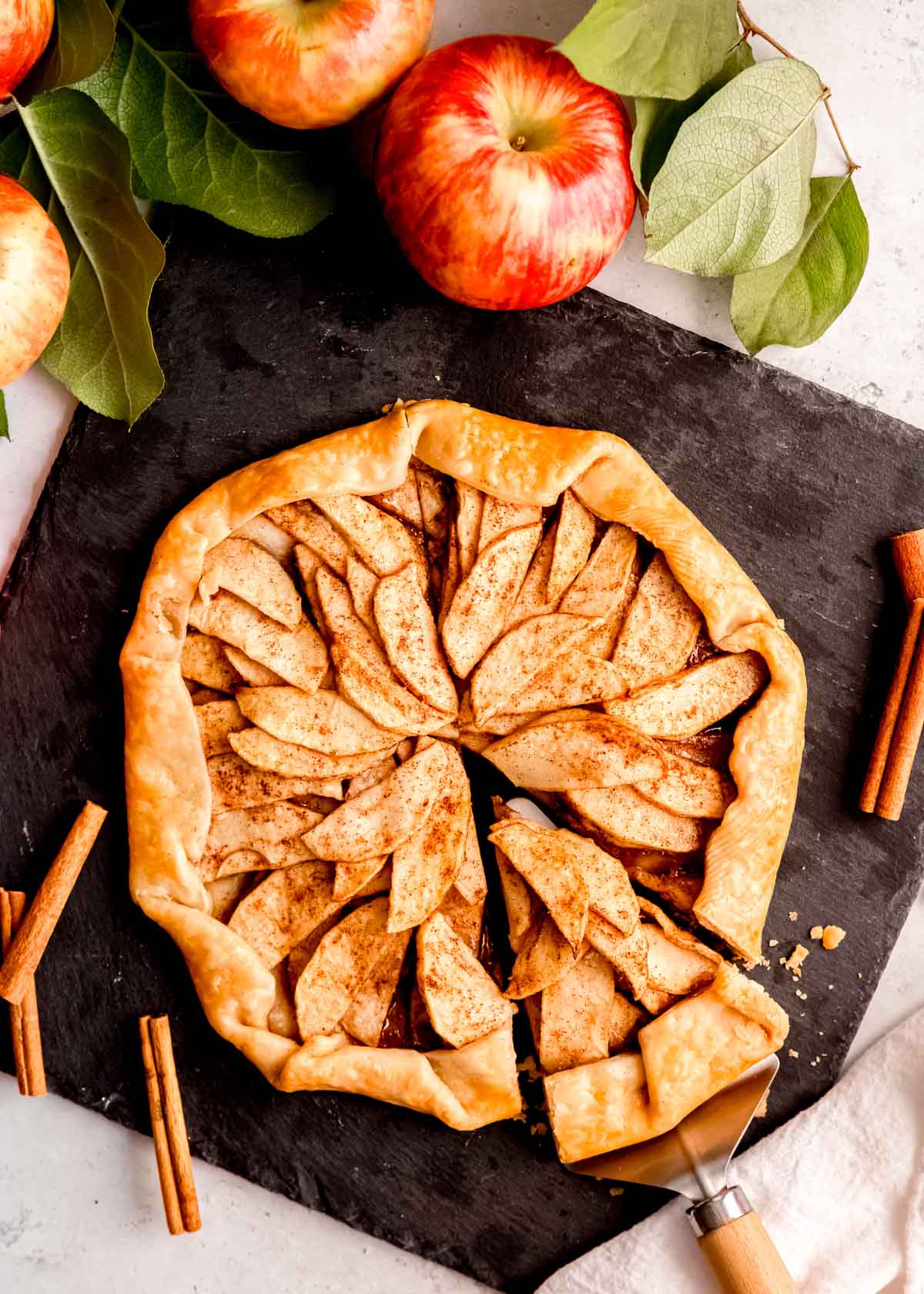 slice being taken from apple galette