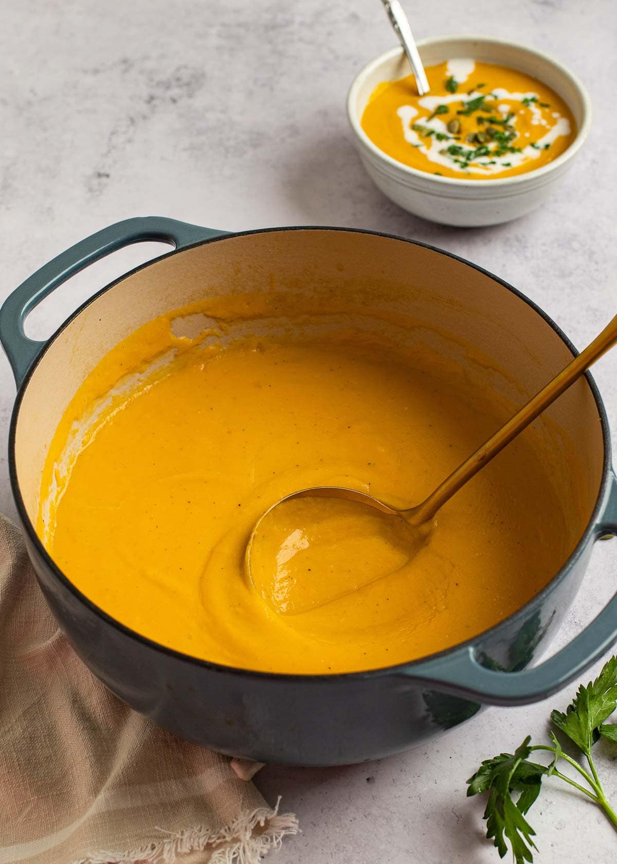 butternut squash soup in a blue pot