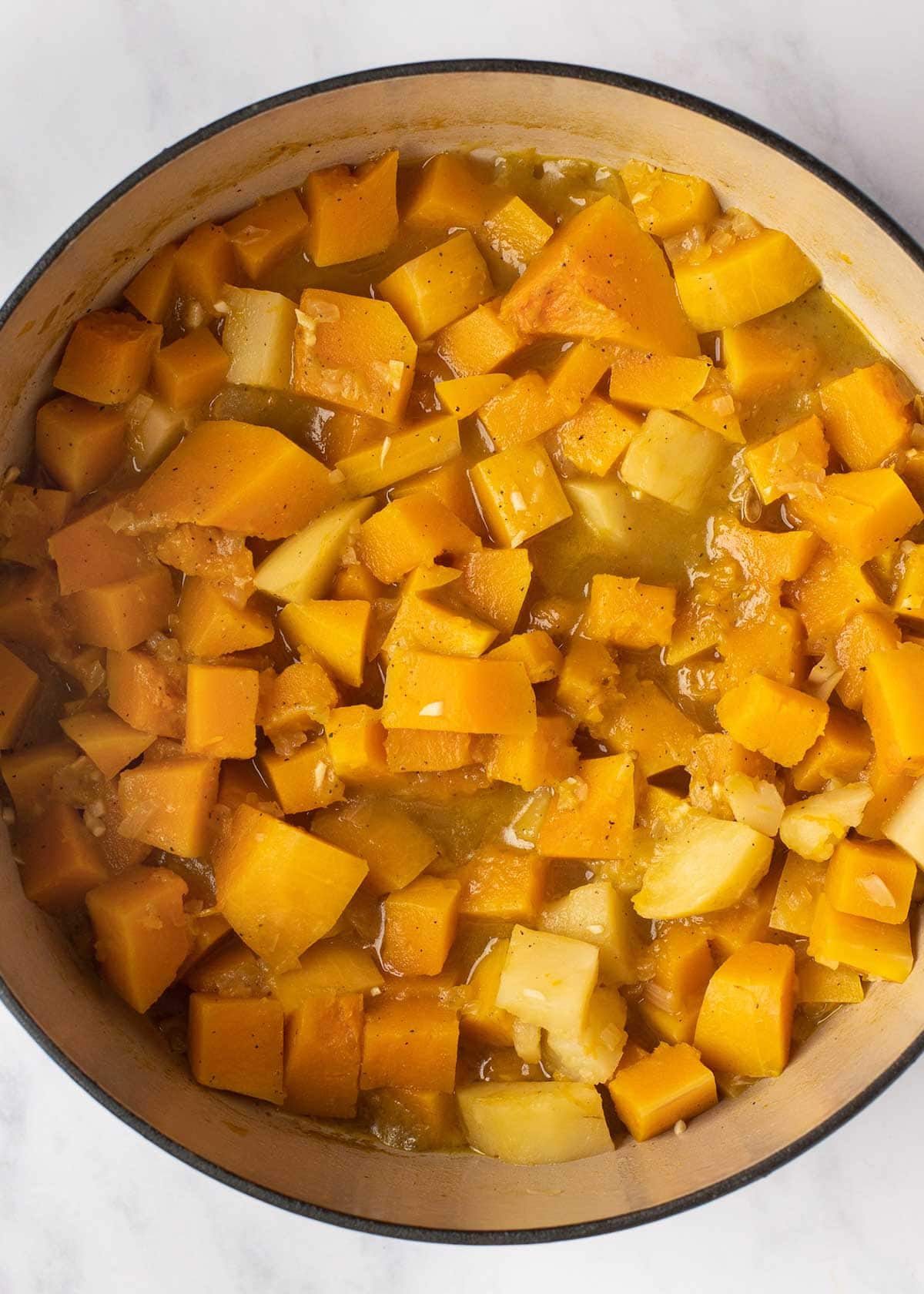 butternut squash ingredients being cooked in a dutch oven