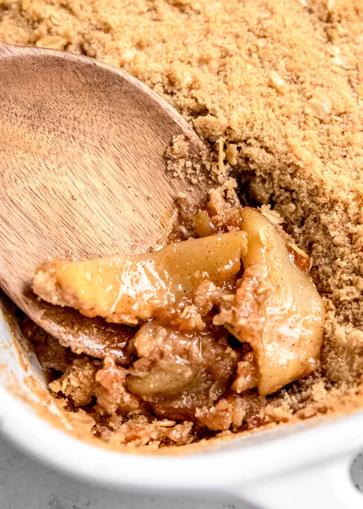 apple crumble in casserole dish with spoon