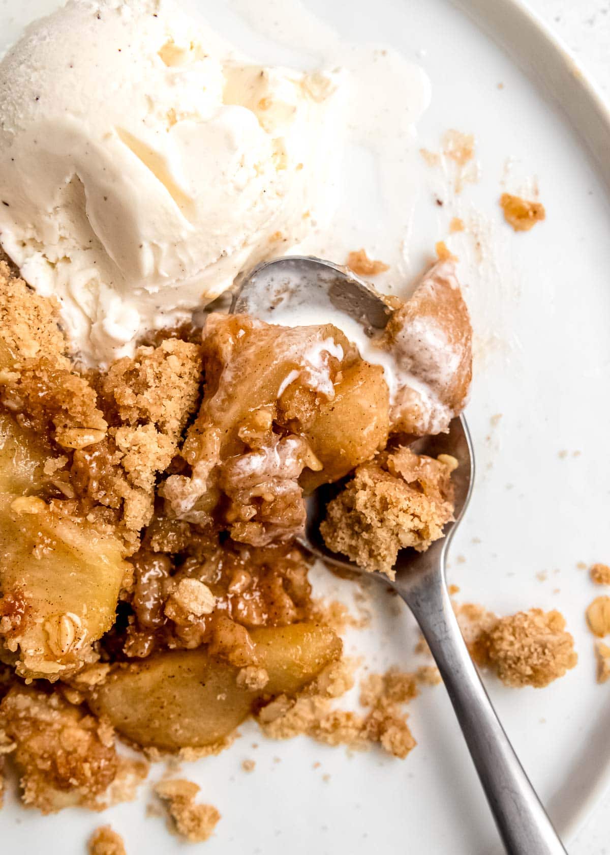 apple crumble on plate with spoon