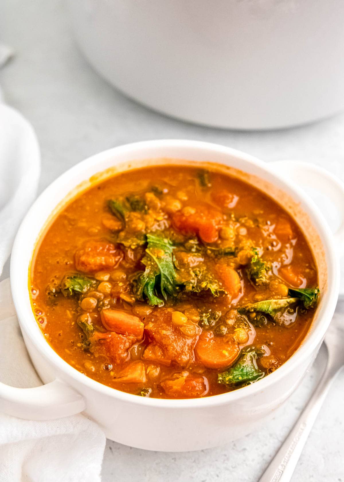 lentil soup in white bowl on white table