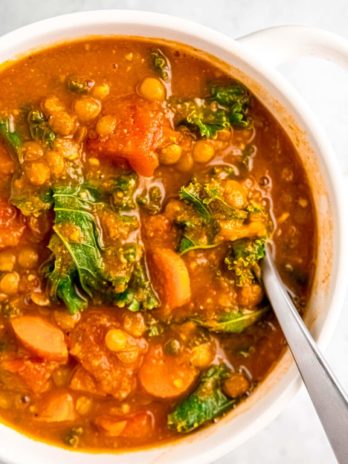 close up of lentil soup in white bowl