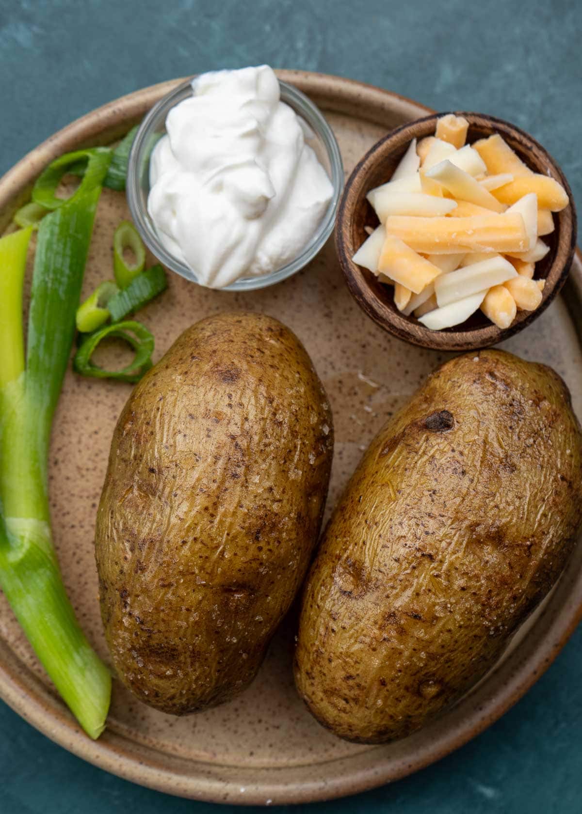 instant pot baked potato ingredients on brown plate 