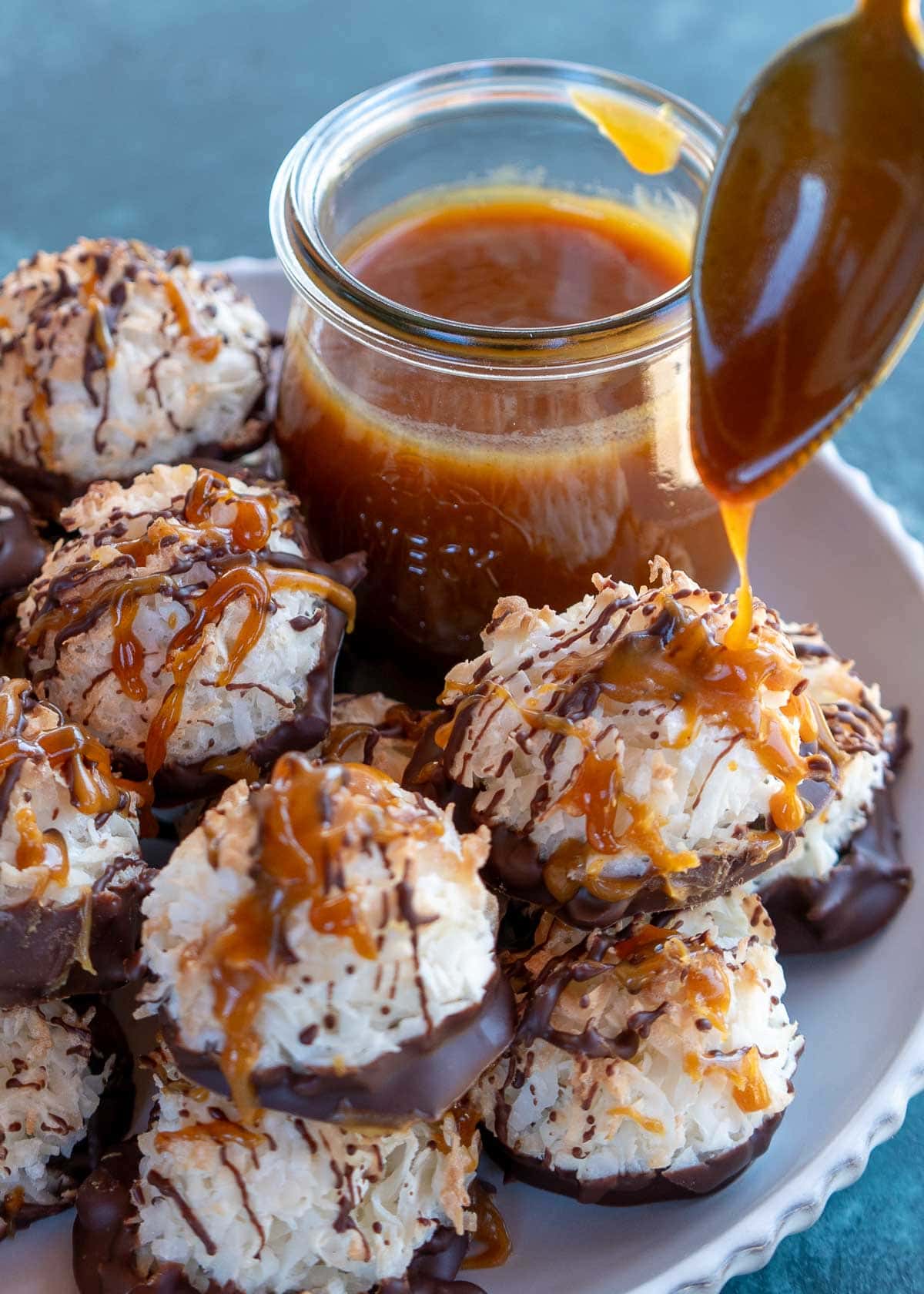 caramel being drizzled on a coconut macaroon