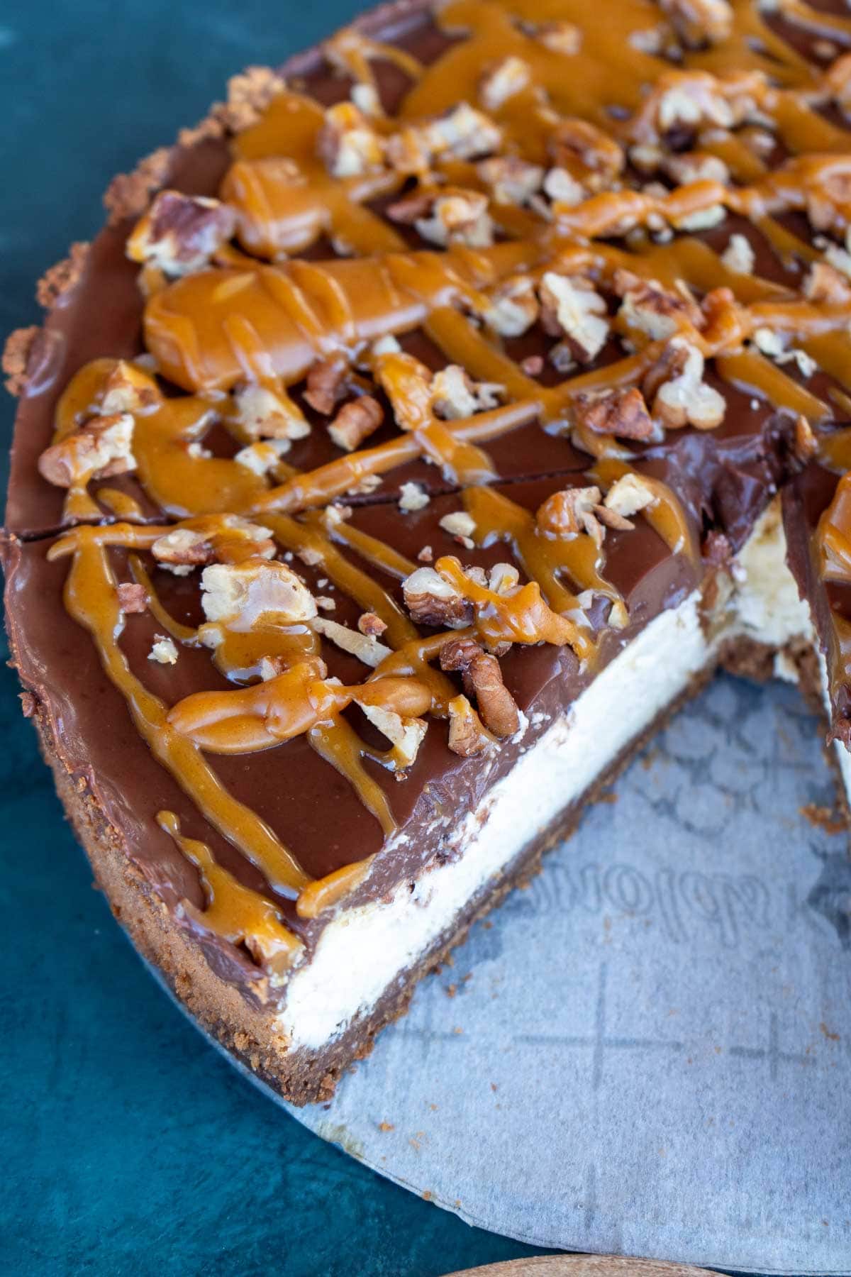 a close up shot of a sliced turtle cheesecake