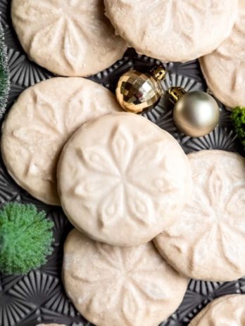 stamped gluten-free cookies on a table with jingle bells