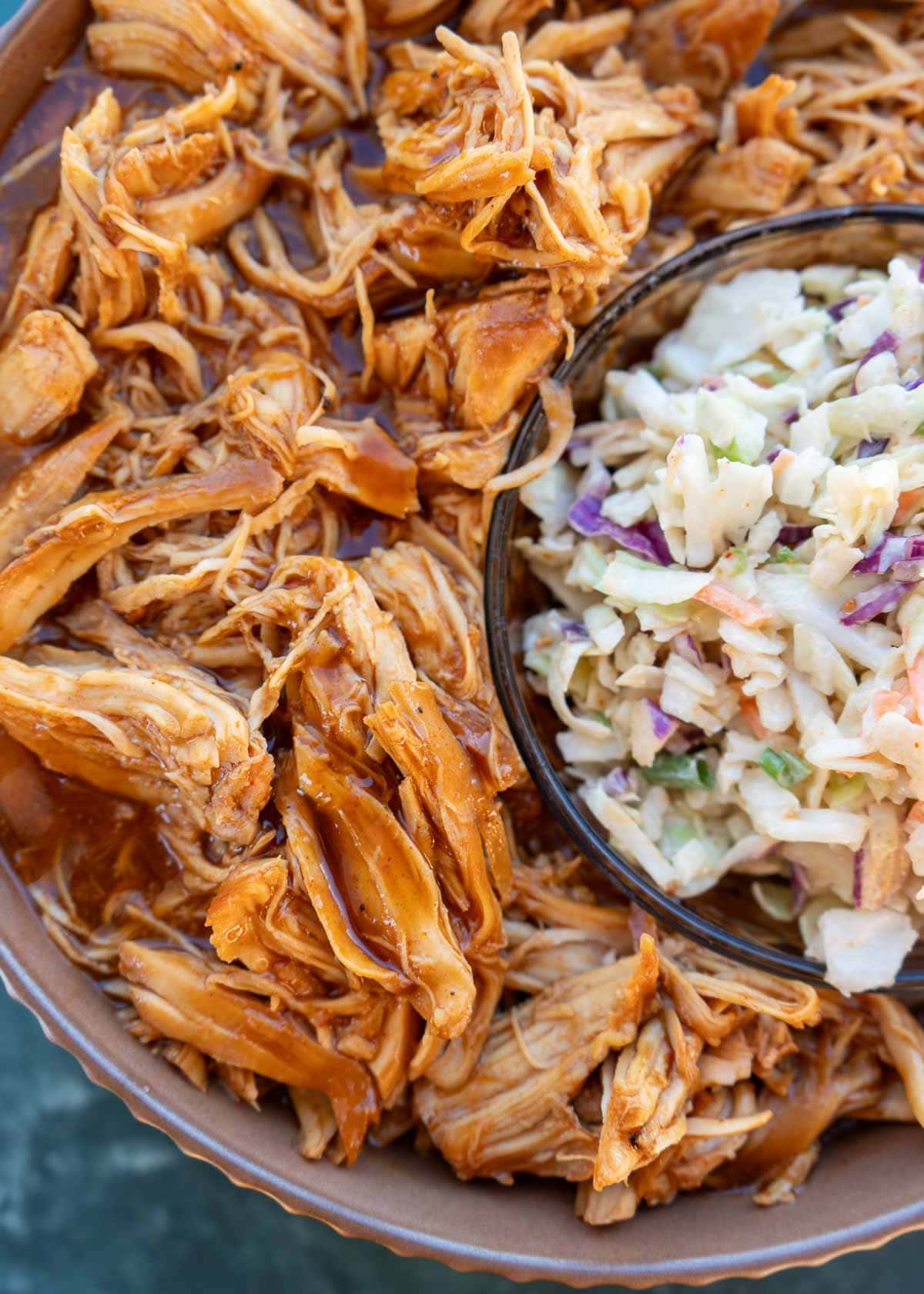 overhead image of shredded bbq chicken and slaw on plate