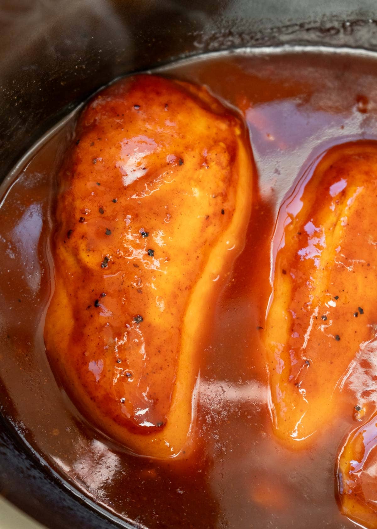 chicken breasts cooked in bbq sauce in a slow cooker