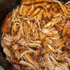 overhead close up image of shredded slow cooker bbq chicken