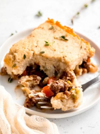 close up of a slice of lightened up shepherd's pie and a bite of food on a fork