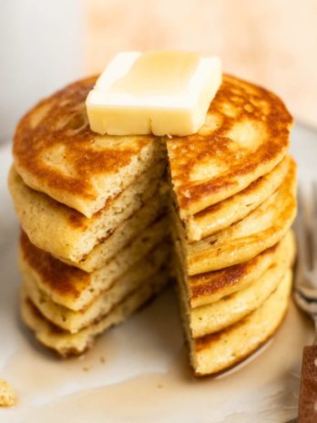 close up image of a slice removed from stack of pancakes