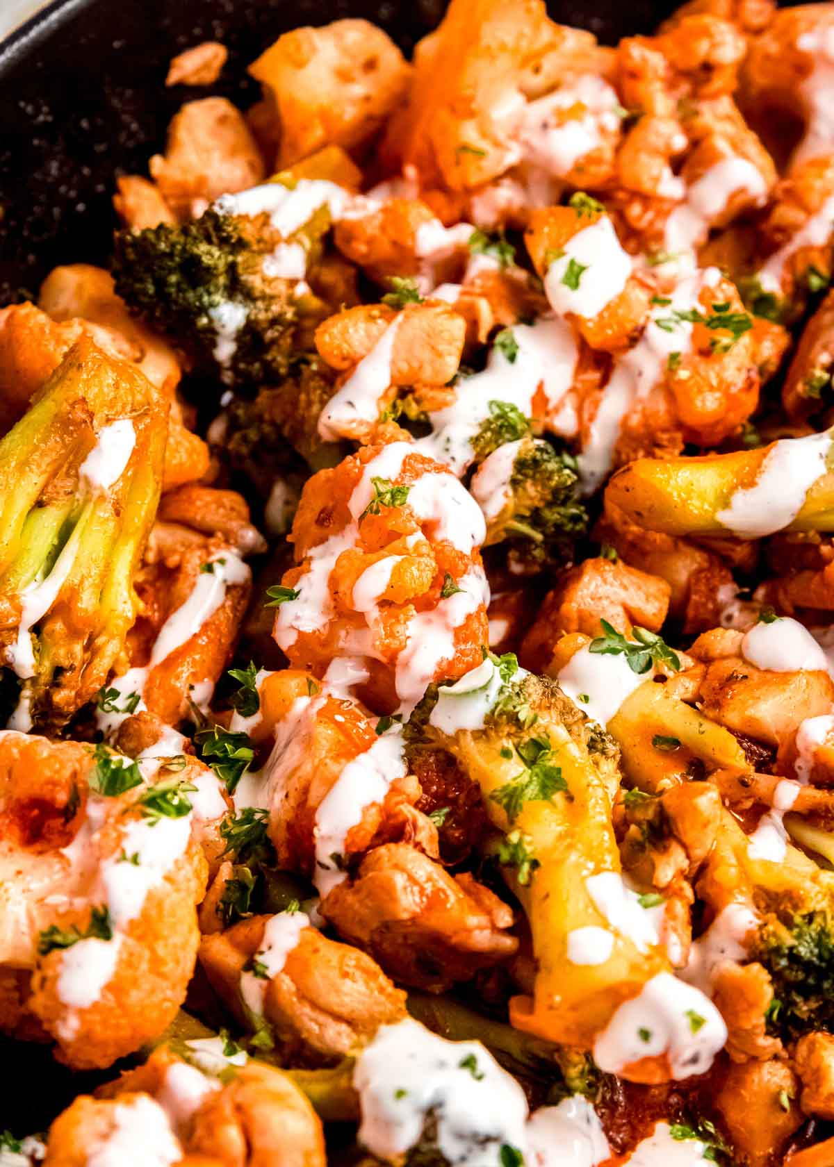 close up image of buffalo chicken skillet in a cast iron skillet