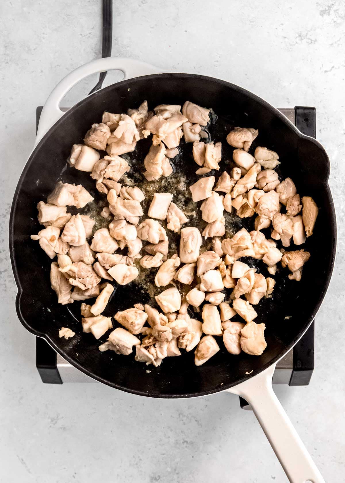 overhead image of cooked chicken in a cast iron skillet