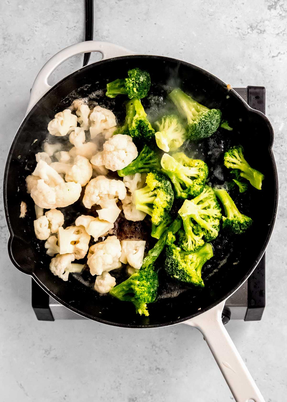 vegetables cooking in cast iron skillet