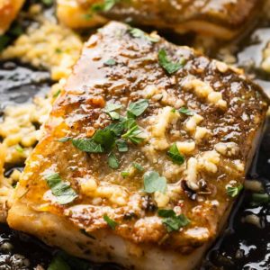 close up of garlic butter cod in skillet