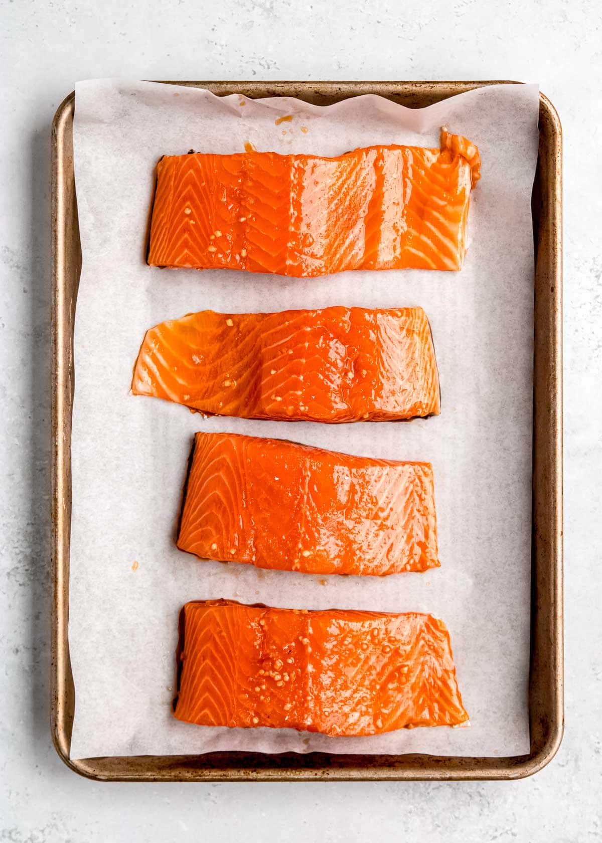 raw salmon on baking sheet